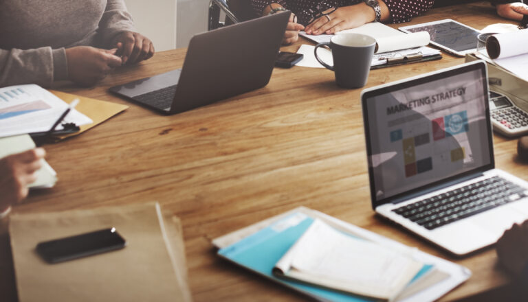 People at Computers Discussing Marketing Strategies