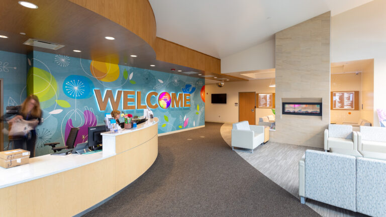 UnityPoint Health Meriter Front Desk Feature Wall LED Back Lit Dimensional Welcome Custom Wallpaper