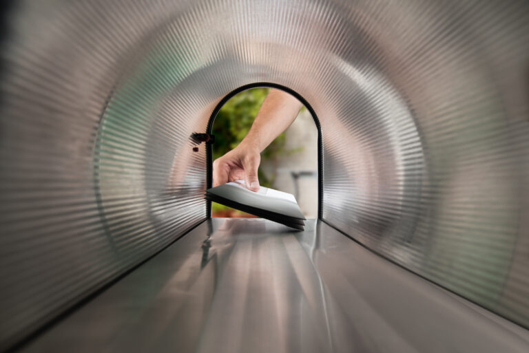 hand taking mail from mailbox.