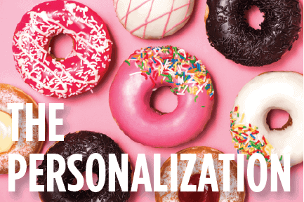 A variety of colorful donuts on a pink background, illustrating personalization in marketing by catering to individual preferences and tastes.