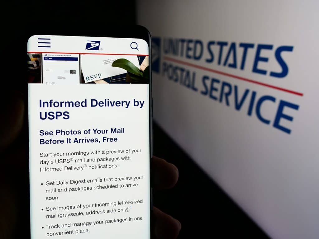 A smartphone screen showing the USPS Informed Delivery service interface, with the United States Postal Service logo displayed in the background.