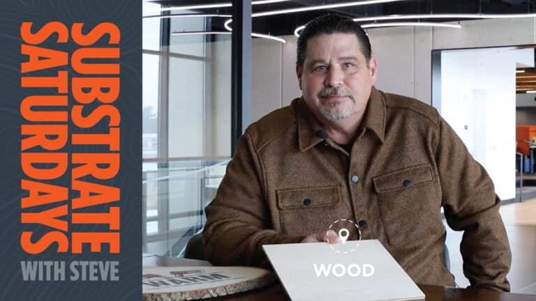 Man in a brown flannel shirt sits at a table holding a sample of wood, with bold text on the left reading “Substrate Saturdays with Steve.” A circular label over the wood reads “WOOD.”