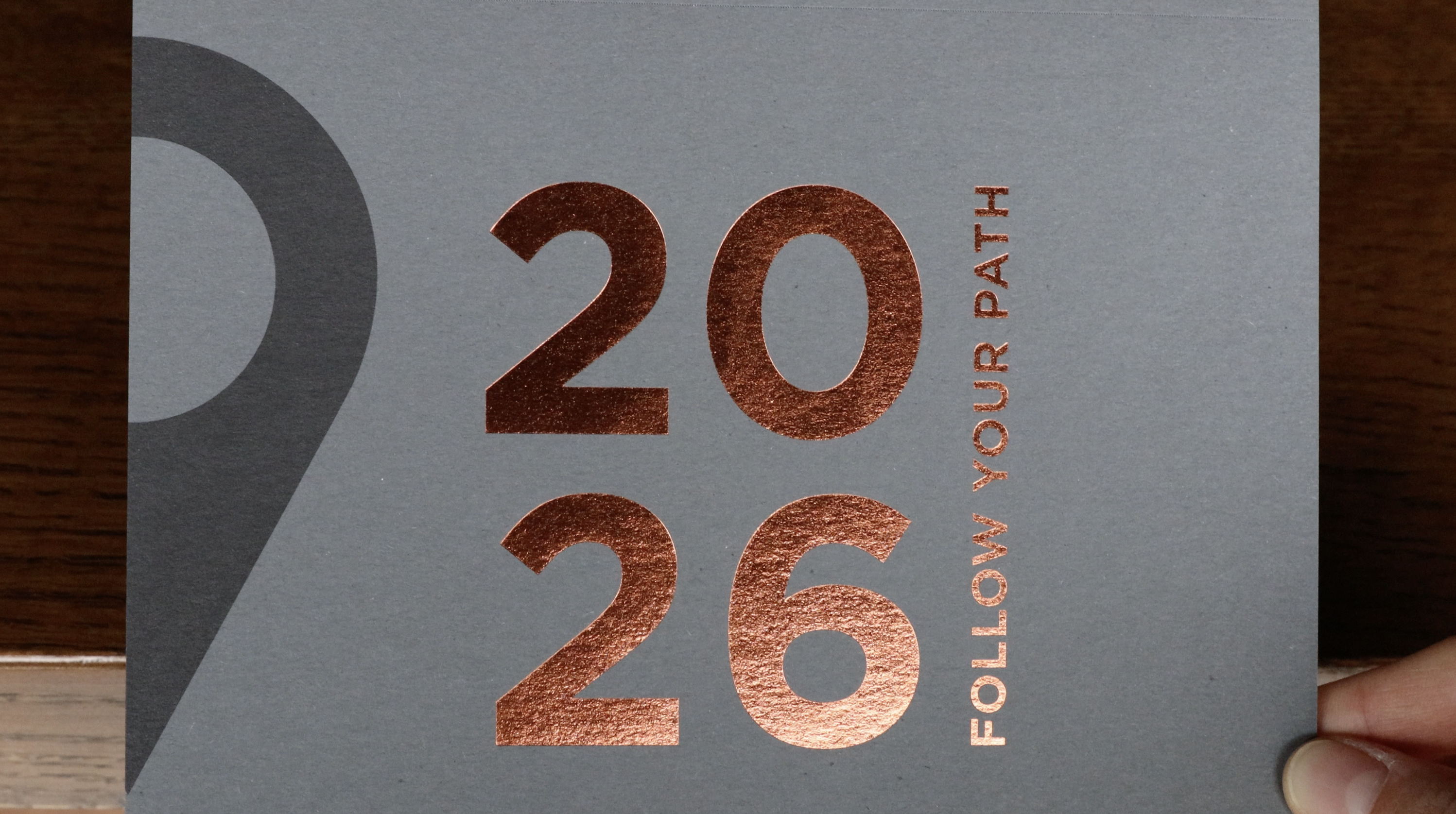 Close-up of copper foil-stamped “2026” and “Follow Your Path” typography on the calendar cover.