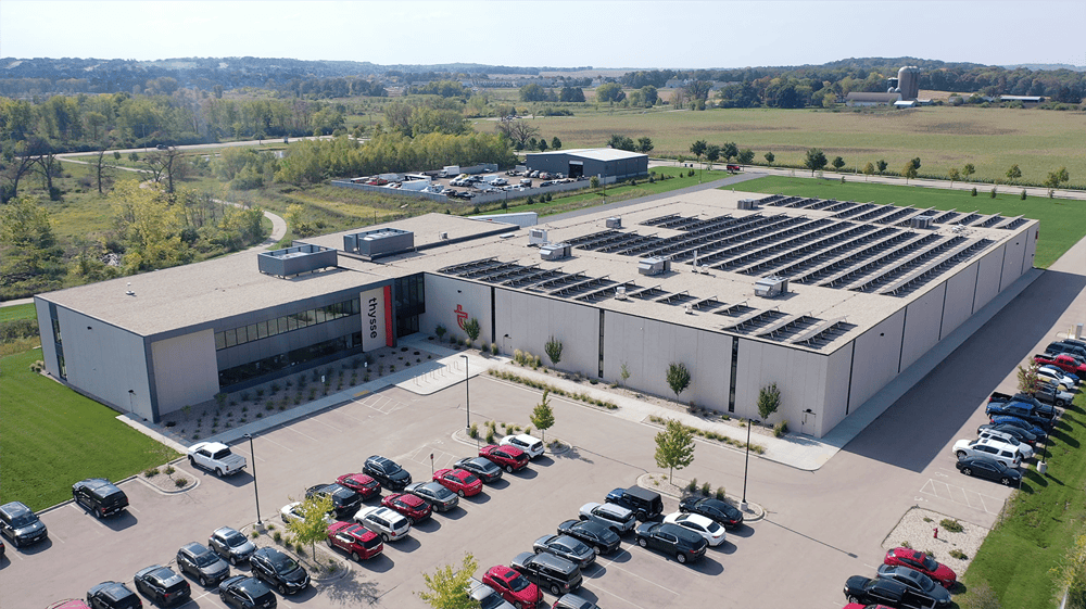 Aerial view of Thysse’s commercial printing facility on Cusick Parkway featuring a solar-powered roof and large-scale production building.