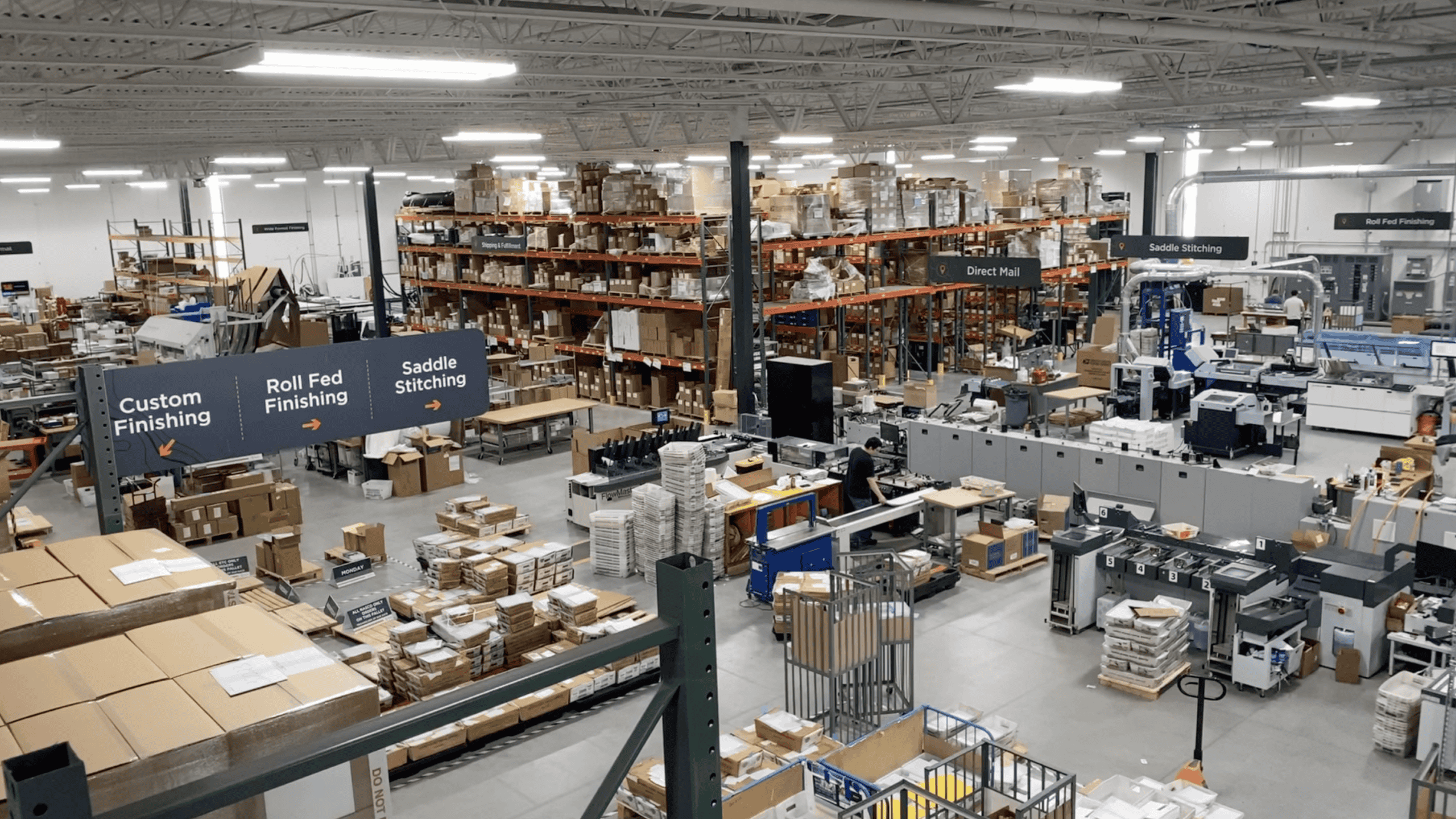 Commercial Printing Warehouse Facility located in Oregon, WI. Image shows warehouse shop floor, cardboard boxes, racking, and printing equipment.