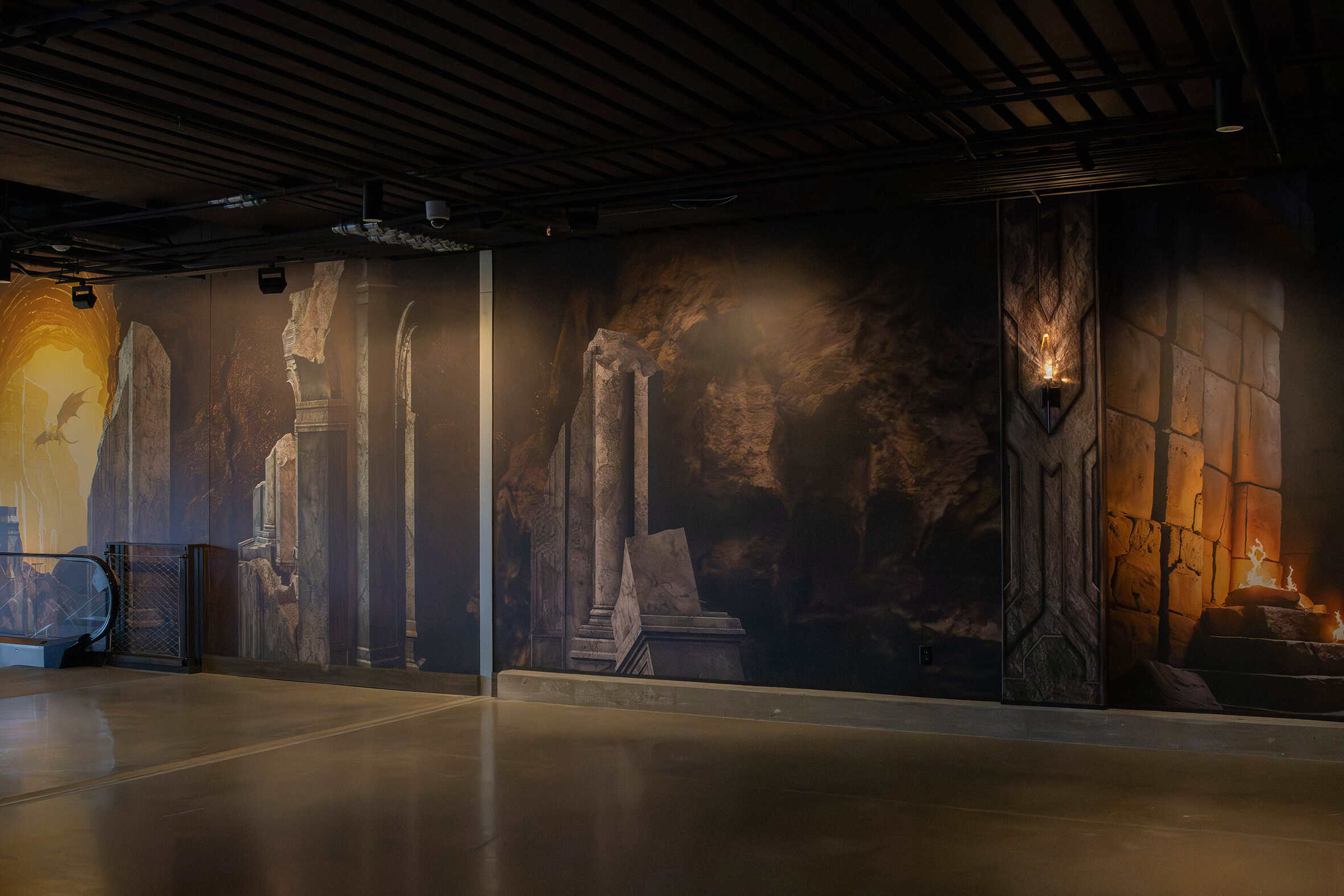 Fantasy-inspired wallcovering along escalator corridor