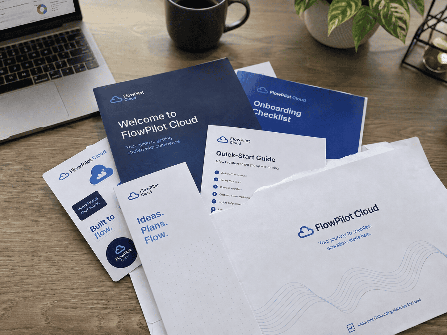 A SaaS company onboarding kit is displayed on a desk, featuring a branded flat mailer envelope, welcome booklet, quick-start guide and onboarding checklist for a new business customer.