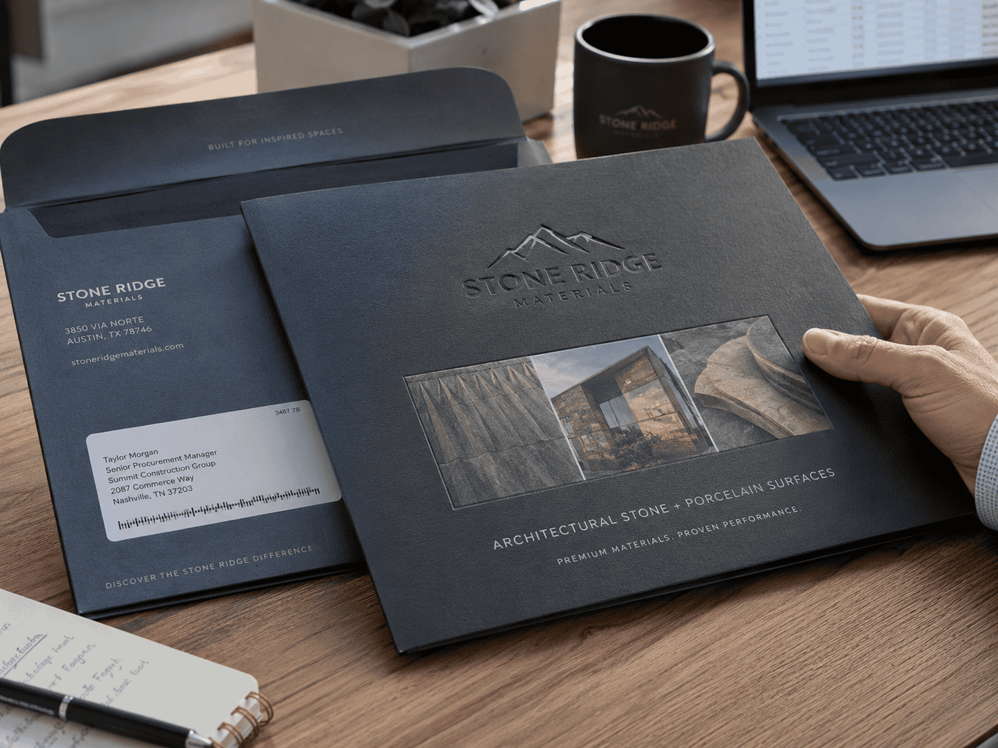 An embossed business-to-business flat mailer from Stone Ridge Materials sits on a desk beside its matching envelope, showcasing textured print and premium architectural materials branding.